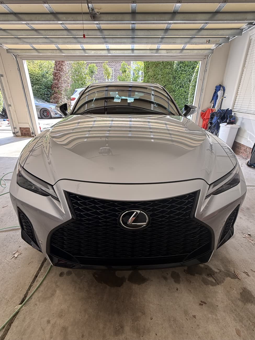 Silver Lexus IS front end with a glossy finish after a detail