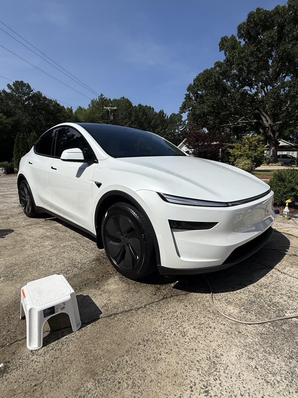 White Tesla Model Y after a full exterior detail with deep gloss