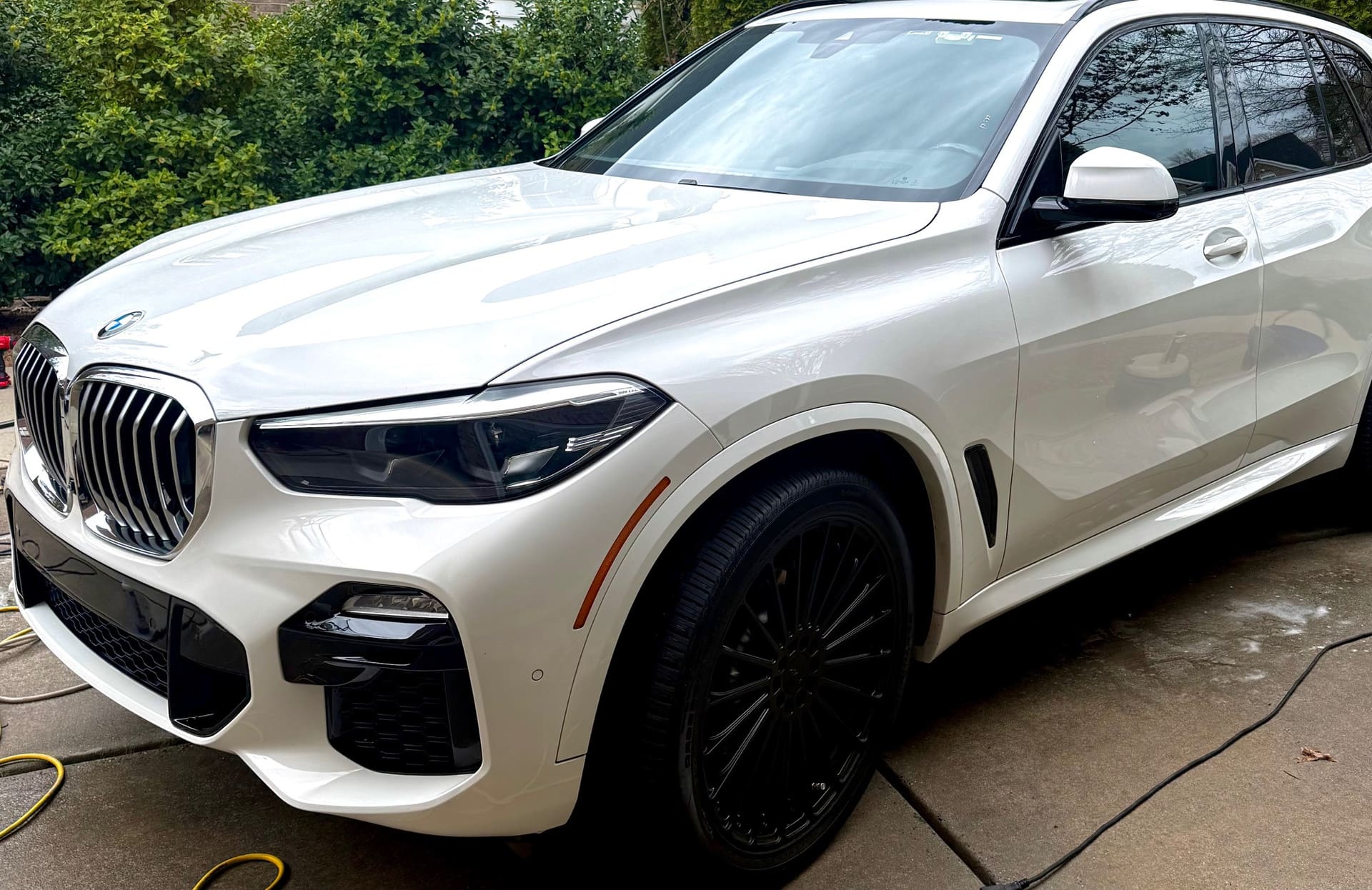 White BMW X5 SUV after a full exterior detail with glossy paint